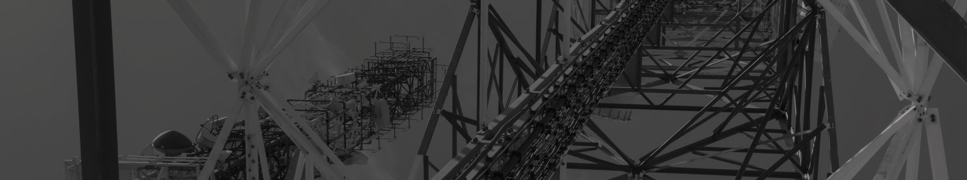 Black and white close-up view of a telecommunications tower